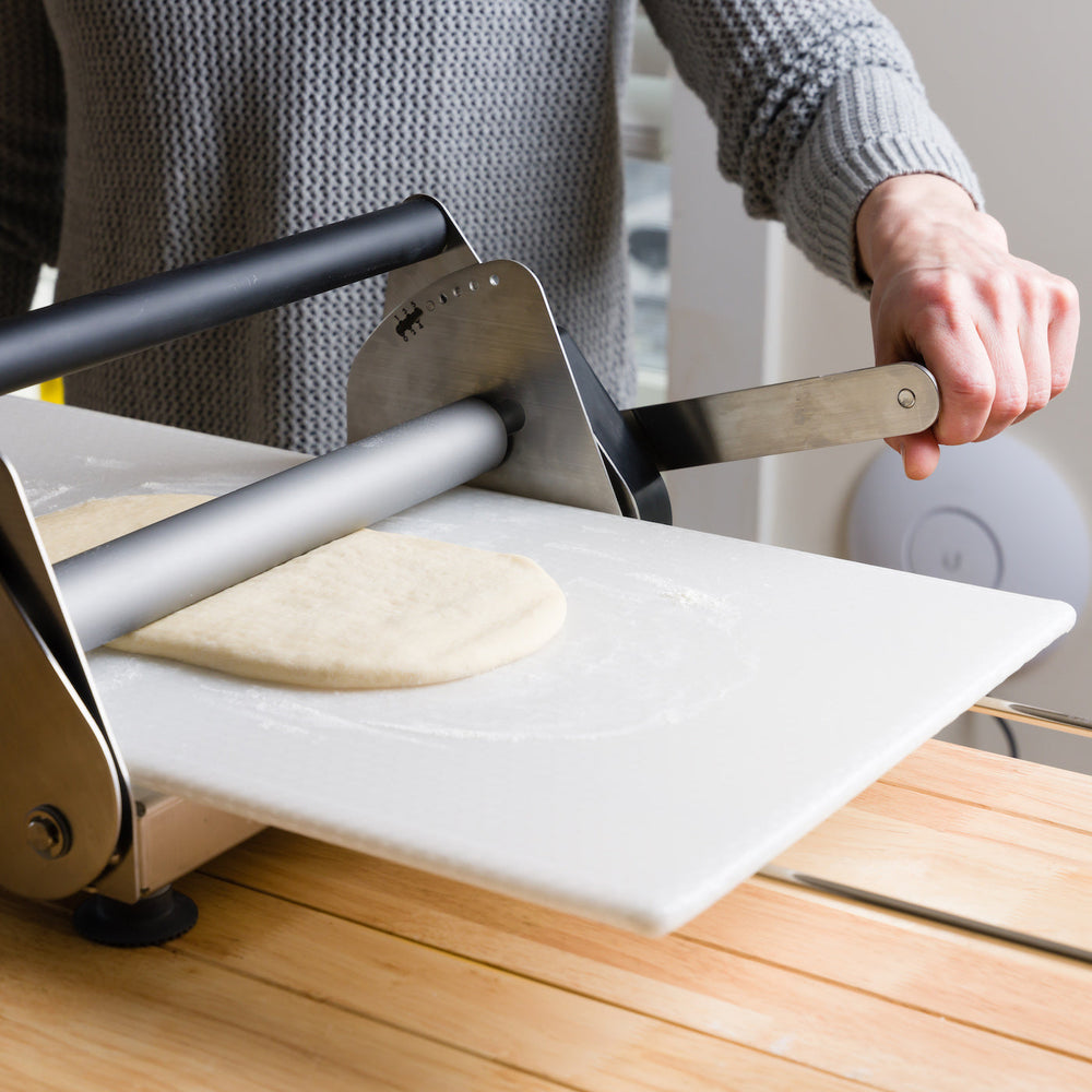 Manually operating the compact dough sheeter
