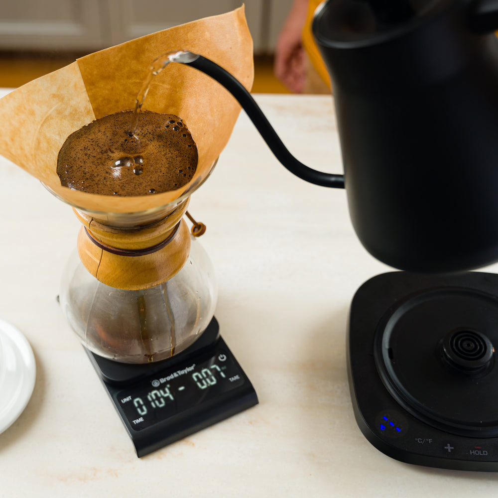 Pouring hot water into a coffee dripper, timing using the Precision Kitchen scale
